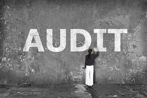 istock businesswoman drawing  audit on the wall 526748001