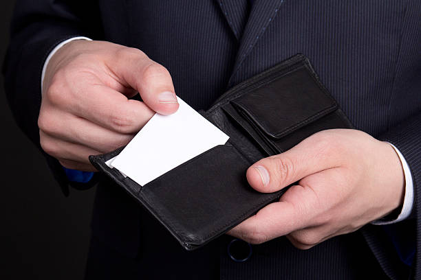istock purse with visiting card in business man hand 526749545