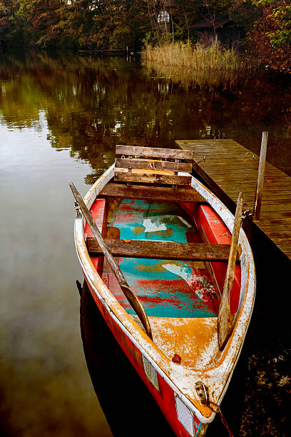 istock Old rowboat on a lake in autumn, Germany 526749637