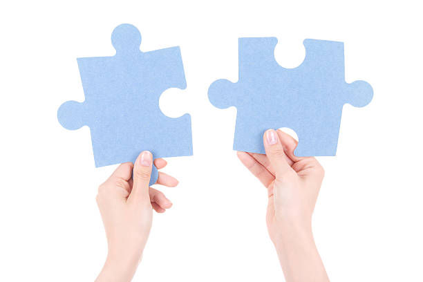 istock puzzle pieces in woman hands isolated on white 526763109
