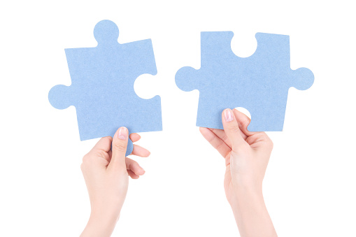 puzzle pieces in woman hands isolated on white background