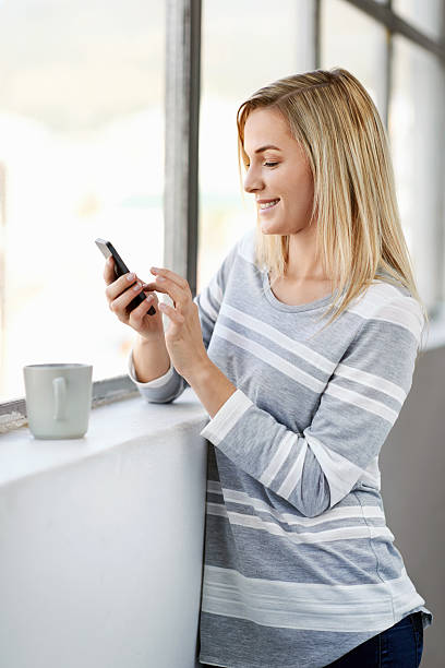 istock woman coffee phone 526766625