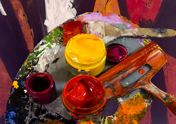 COLORS IN ACTION PAINT CONTAINER ON AN ARTIST'S PALETTE creación stock pictures, royalty-free photos & images