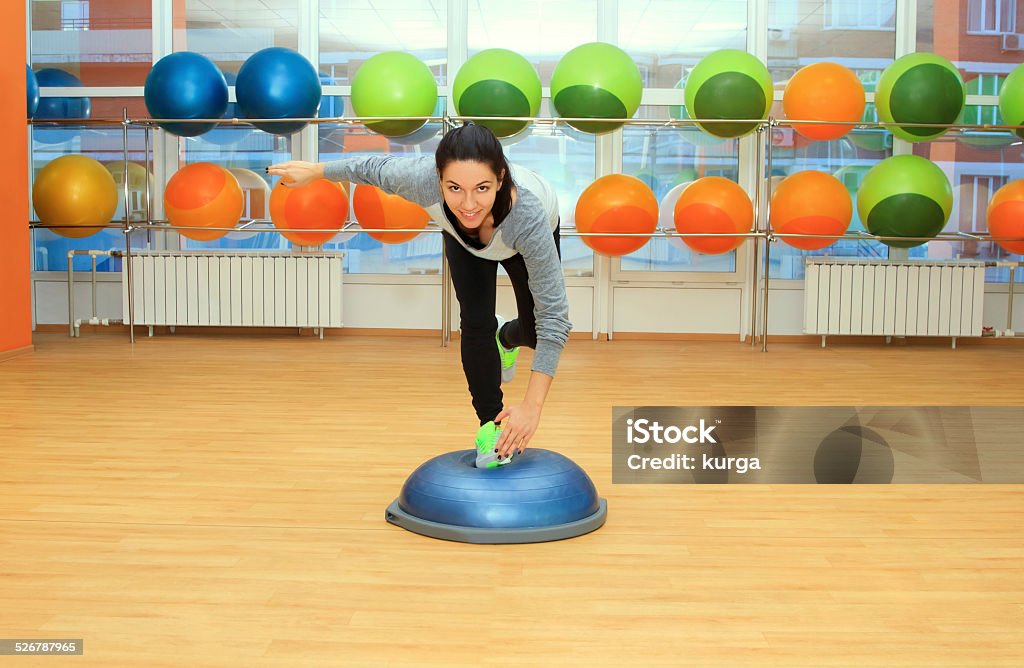 Young woman doing exercise on bosu ball Balance Stock Photo