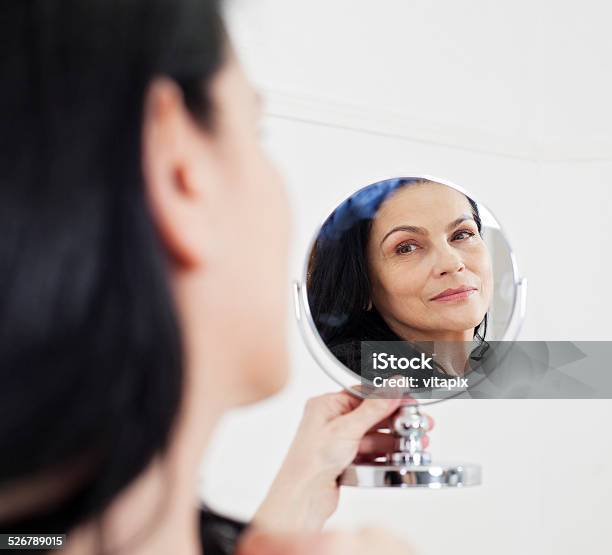 Beautiful Mature Woman Looking In The Mirror Stock Photo - Download Image Now - Women, 50-59 Years, Candid