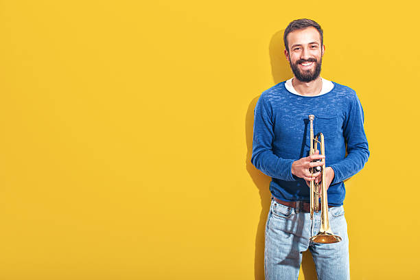 Trumpet player Smiling trumpet player, ready to play man trumpet stock pictures, royalty-free photos & images