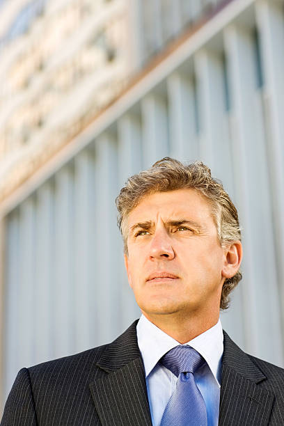 istock Businessman Looking Away Against Office Building 526791047