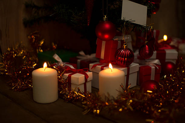 istock Christmas gifts under the tree with candlelight 526805279