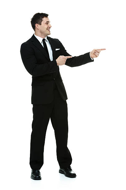 istock Cheerful businessman pointing away 526805503