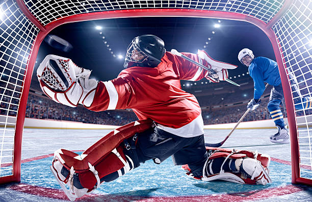 ice hockey player-punkten - ice hockey hockey puck playing shooting at goal stock-fotos und bilder