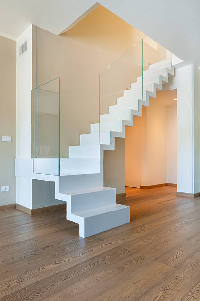 istock Interior white iron and glass staircase and wooden floor 526807227