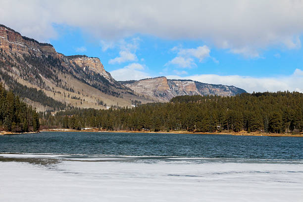 istock Lake starting to freeze over with light snow on ice 526807277