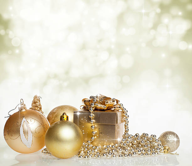 istock Christmas decorations and golden gift box on sparkling backgroun 526807599