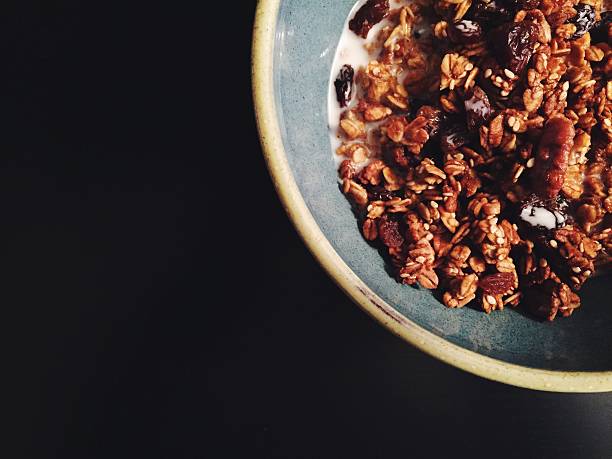 Homemade pumpkin granola on dark background with copy space