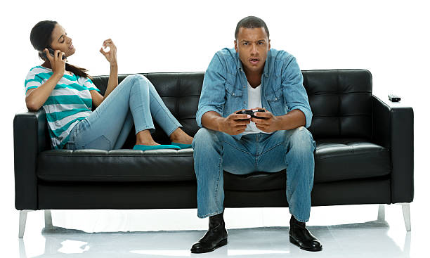 istock Man playing video game while woman on mobile 526811253