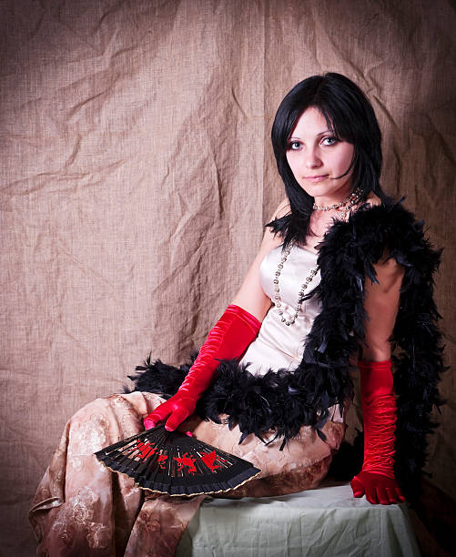 istock Girl with fan and boa posing in studio 526811425