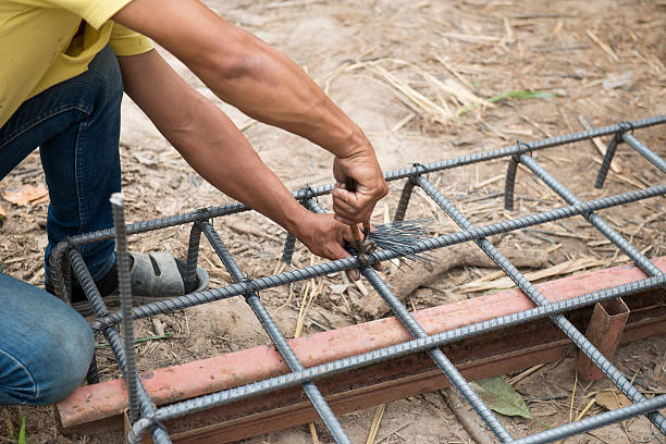 istock workers are  preparing steel poles for building house 526811477