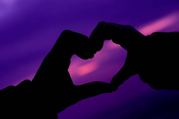 istock Purple heart symbol made with hands 526812777