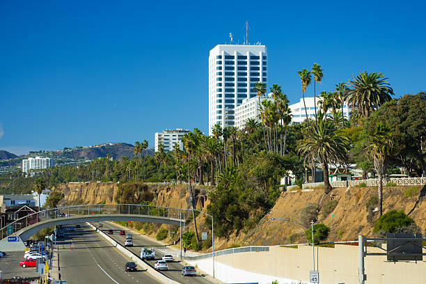 istock Santa Monica skyline with the PCH, palm trees, and mountains 526819040
