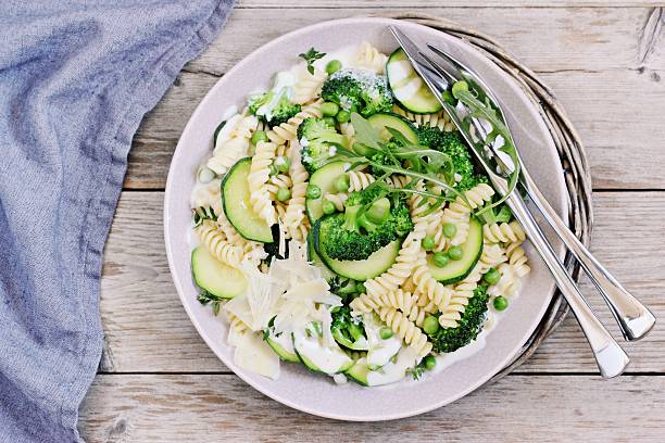 istock Pasta with broccoli,zucchini and green pea. 526819634