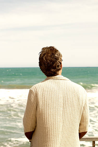 istock Pensive Man Alone Looking Out to Sea 526819744