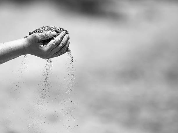 istock woman hands holding sand 526820326