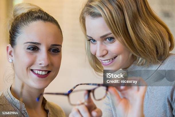 Choosing Glasses At The Optician Stock Photo - Download Image Now - 20-29 Years, Adult, Arts Culture and Entertainment