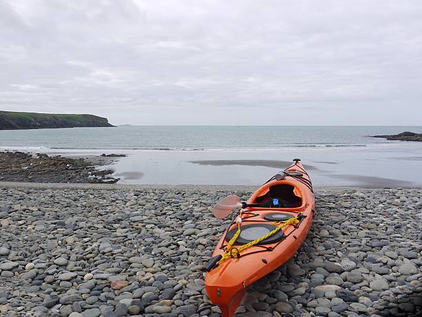 istock Canoe at edge of sea 526821996