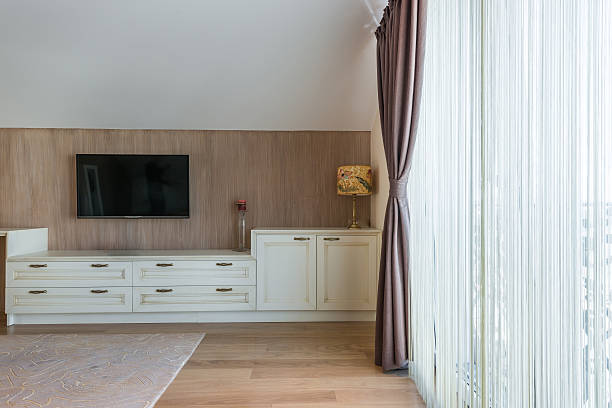 istock White wooden commode with tv unit near big window 526823046