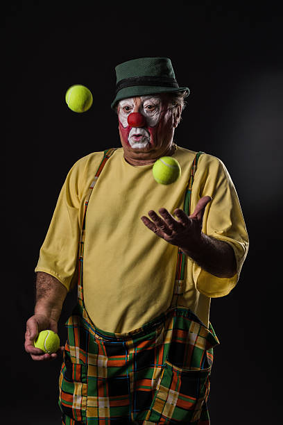 istock old-aged clown juggles  with tennis balls 526823876