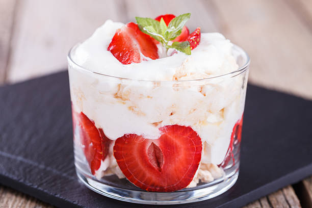 Eton Mess - Strawberries with whipped cream Eton Mess - Strawberries with whipped cream and meringue in a glass beaker. Classic British summer dessert.selective focus strawberry crush stock pictures, royalty-free photos & images