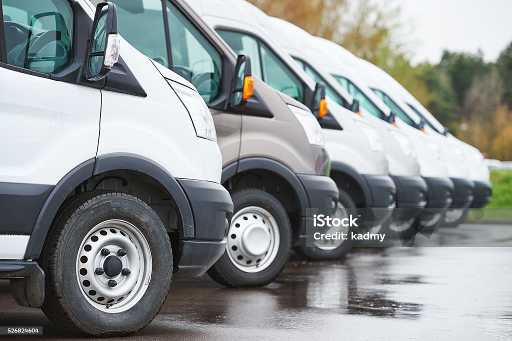 transporting service company. commercial delivery vans in row freight services. commercial delivery vans in row at transporting carrier shipping service company parking Mini Van Stock Photo