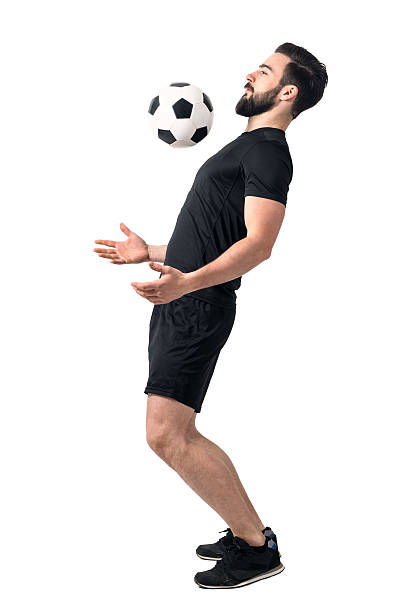 Soccer futsal player stopping the ball with his chest. Soccer futsal player stopping the ball with his chest. Full body length portrait isolated over white background. man chest shirt stock pictures, royalty-free photos & images
