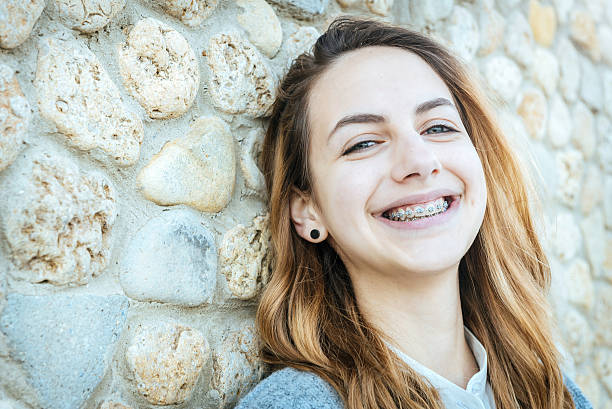 Beautiful smiling girl with retainer for teeth  . stock photo