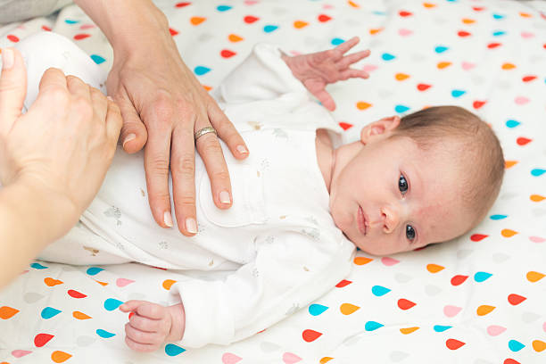 istock Newborn baby dressed in white laying on her back 526824924