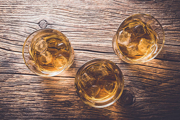 istock Glasses of whiskey on wooden table 526825568