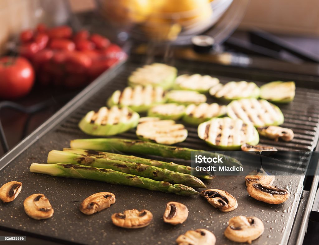 Vegetables on grill Asparagus, mushrooms and zucchini on electrical grill Barbecue Grill Stock Photo