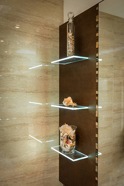 Glass shelf in bathroom with ornaments and decorations, earth tones