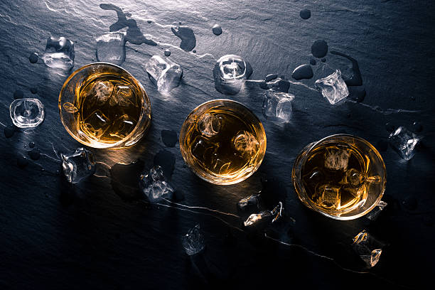 istock Glasses of whiskey on dark table 526826404