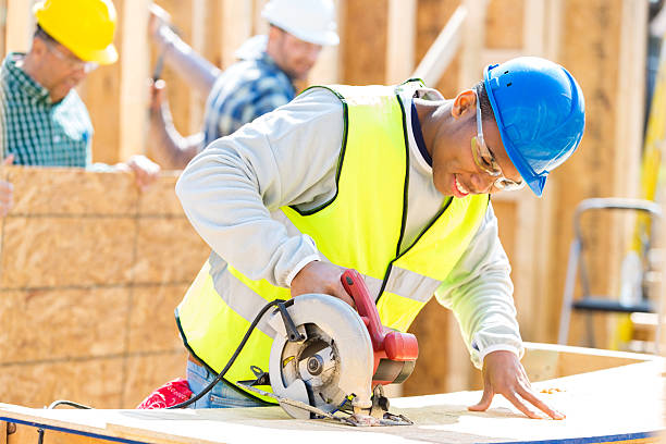 istock Yong African American man uses power tool at construction site 526826454