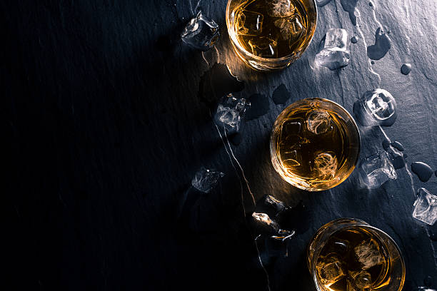 istock Glasses of whiskey on dark table 526826500