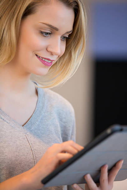 istock Portrait of a smiling woman using a touchpad 526826790