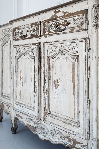 istock Close-up of ancient white commode bureau furniture with paint 526826912