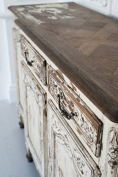 istock Close-up of ancient white commode bureau furniture with paint 526826986