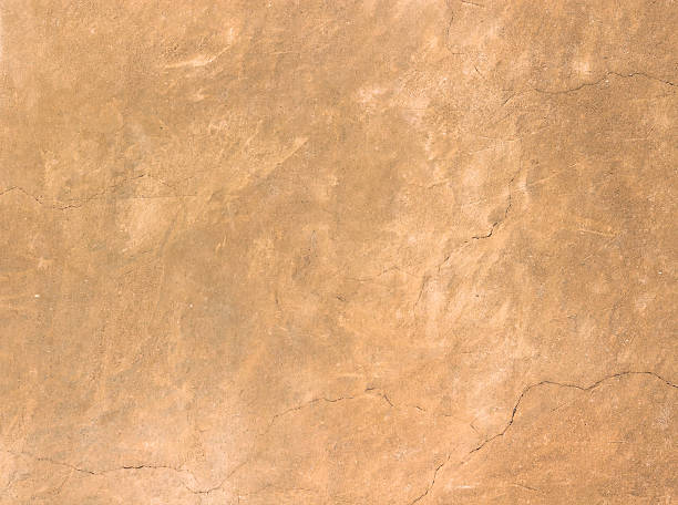 Rustic wall Texture of old rustic wall covered with brown stucco sandstone stock pictures, royalty-free photos & images