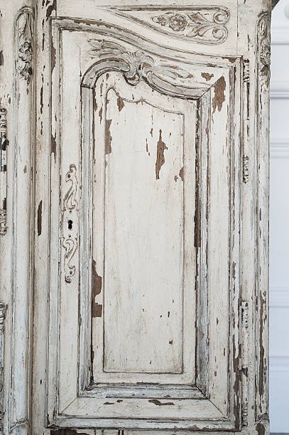 istock Close-up of keyhole ancient white commode bureau furniture with 526827408