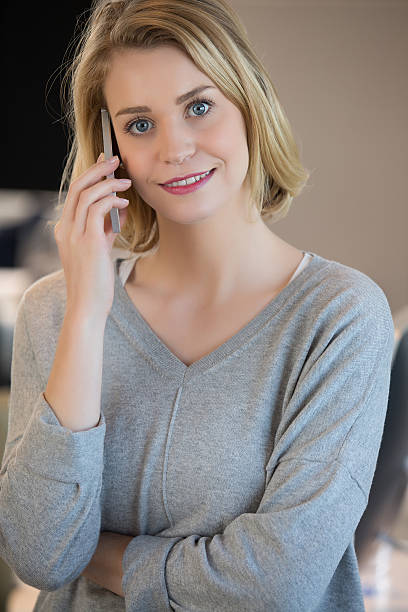 istock Beautiful girl using her mobile phone in cafe. 526828250