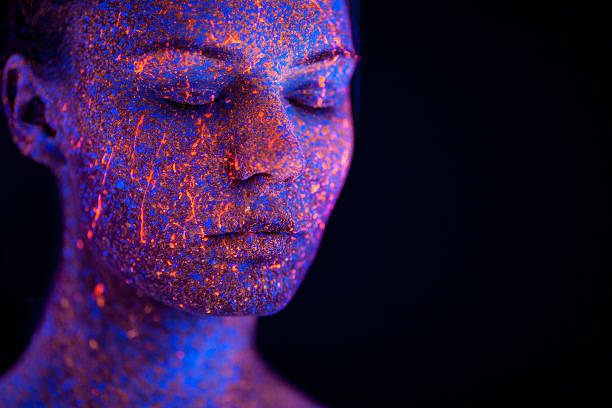 istock Portrait painted with fluorescent makeup under the ultraviolet l 526829100
