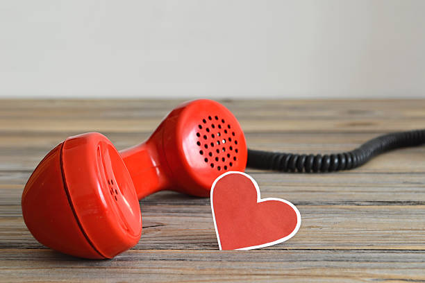 istock Vintage red telephone handset and heart shaped tag 526829872