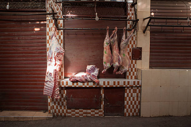 Meat hanging outside a butcher's shop in the medina. stock photo